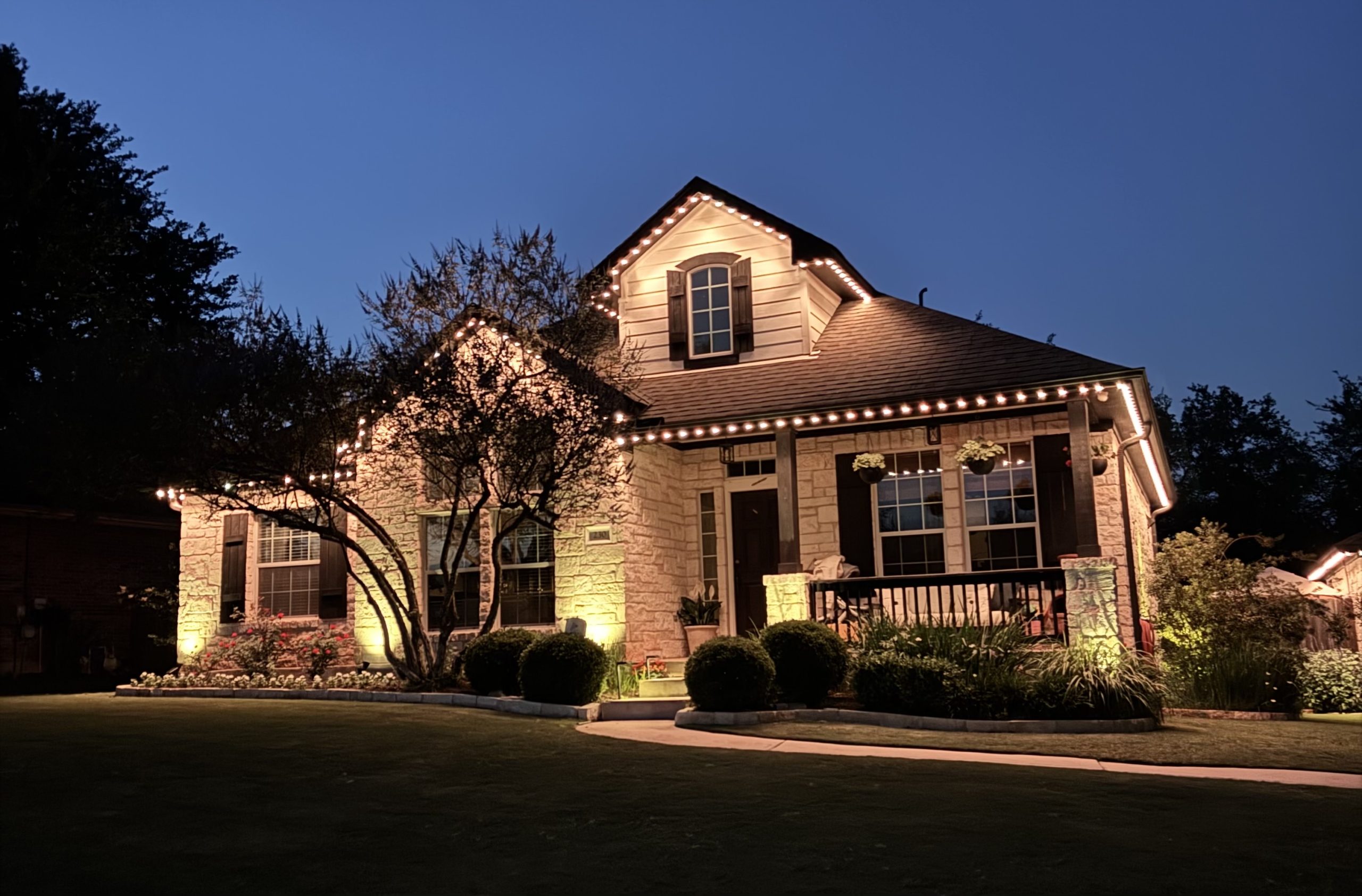Permanent LED roofline lighting on an Austin home at twilight — installed by Zeus Illumination